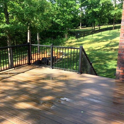 Siding by the Best - newly renovated deck with iron railings
