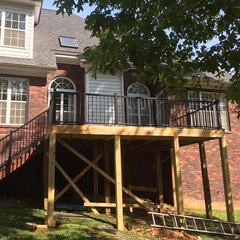 Siding by the Best - newly renovated deck with iron railings and stairs
