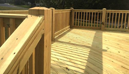 Siding by the Best - newly built wooden deck in sunlight
