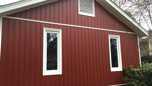 Siding by the Best - freshly painted home red with white trim