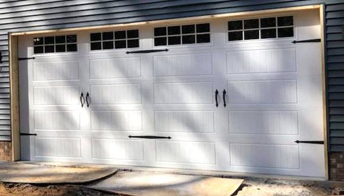 Siding by the Best - newly painted garage door in white with black hardware