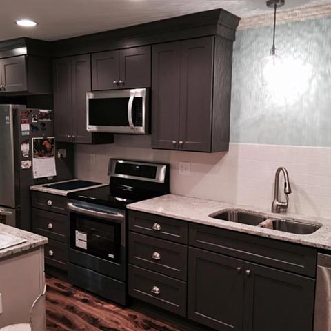 Siding by the Best - newly renovated kitchen with granite countertops and dark cupboards