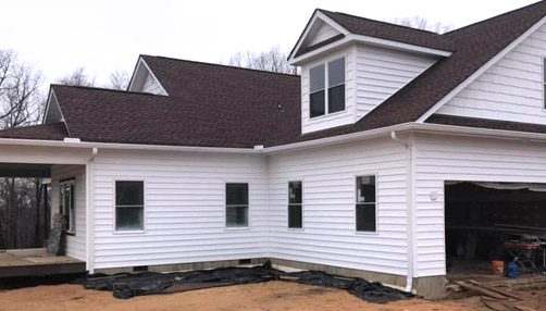 Siding by the Best - new white siding and new roof installed on home