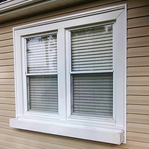 Siding by the Best - freshly painted trim on windows of home