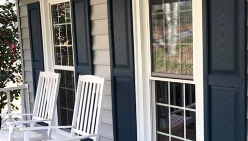 Siding by the Best - freshly painted trim on windows facing front porch of home